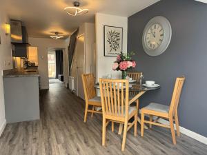 a dining room and kitchen with a table and chairs at Stanley Cottage in Herne Bay