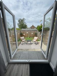 a view of a patio with two chairs and a table at Stanley Cottage in Herne Bay