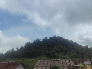 a mountain in the distance with a house at Tvkhomestay in Vālpārai
