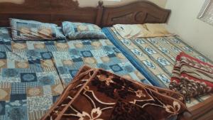 a bed with a quilt and pillows on it at Tvkhomestay in Vālpārai