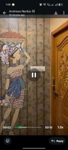 a picture of a cartoon on the wall of a room at Tvkhomestay in Vālpārai
