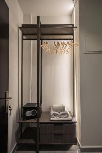 a shelf with a mirror in a room at FEDRA HOTEL in Paralia Katerinis