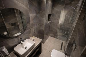 a bathroom with a sink and a shower and a toilet at FEDRA HOTEL in Paralia Katerinis +82 photos