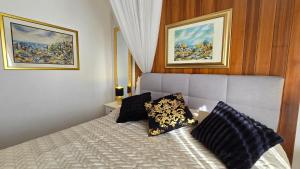 a bedroom with a bed with two pillows on it at Avalena Residence in Zadar