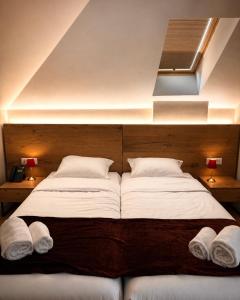a bedroom with a large bed with two white pillows at Hotel Protino in Fushë-Prezë
