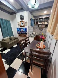 a living room with a table and chairs and a couch at Tiya Cheding Boarding House in Carolina