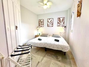 a small bedroom with a bed and a staircase at The Bajondillo terrace in Torremolinos