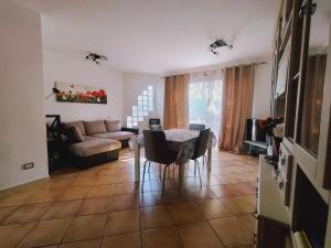 a living room with a table and a couch at Villa Sonia in Maddalenedda