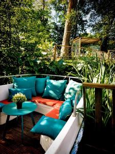a couch with pillows sitting on a patio at La Clef des Ondes in Magescq