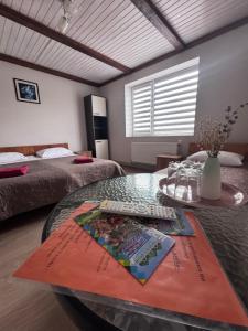 a room with two beds and a glass table at Панська Садиба in Mykulychyn +88 photos