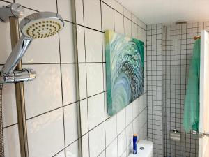 a bathroom with a shower with a shower head at Apartamento Los Lagos Renovated New Kitchen & More in El Cotillo +77 photos