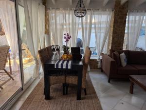 a dining room table with a bowl of fruit on it at Villa eco Electra in Nikiti