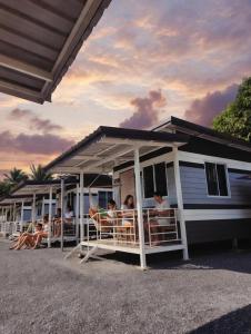 a group of people sitting on the porch of a house at Cloud Bed Ao Nang- High Speed internet, Comfort bed , Smart Tv in Ao Nang Beach