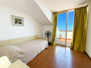a bedroom with a bed and a large window at Appartamenti Napoleone al Poggio - ArgonautiVacanze in Poggio +17 photos