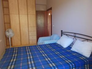 a bedroom with a bed and a chair and a door at Διαμέρισμα τεσσάρων ατόμων in Filiatra +17 photos
