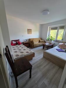 a living room with two beds and a couch at Ночлеги - Pokoi in Tarnowo Podgórne +51 photos