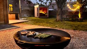 a fire pit in a yard with a grill at Le Clos Boréal - Gîte Spa Privatif in Lens