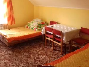 a room with a bed and a table and chairs at Noclegi Renata in Solina +25 photos