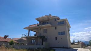 a large white house with a balcony at Apartments BIA in Gevgelija