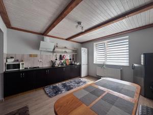 a kitchen with a table in the middle of a room at Панська Садиба in Mykulychyn