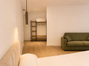a living room with a couch and a chair at Arena House Conil in Conil de la Frontera