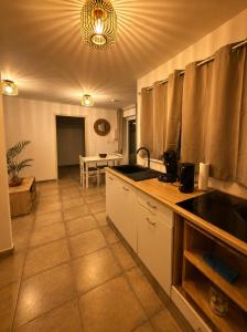 a kitchen with a sink and a counter top at Cocon Romantique in La Saline les Bains
