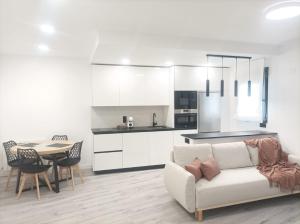 a living room with a couch and a table and a kitchen at El Loft de Cris in Béjar +9 photos