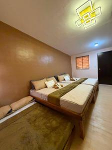 a bedroom with two large beds in a room at Maple Tree by The Guild Oasis Transient House in Rosario +4 photos