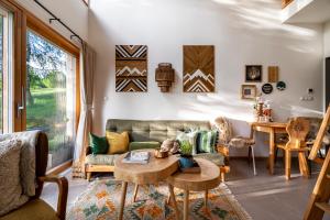a living room with a couch and a table at Wygórowane - nowoczesne stodoły pod Tatrami in Brzegi
