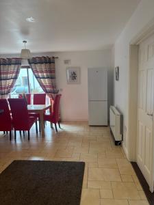 a kitchen and dining room with a table and chairs at Luxury Town House-Apartment Carrick-on-shannon in Carrick on Shannon