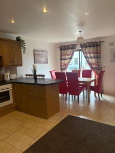 a kitchen and dining room with a table and chairs at Luxury Town House-Apartment Carrick-on-shannon in Carrick on Shannon