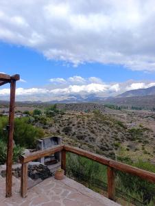 a view of the mountains from a deck with a stove at Tierra Potrerillos in Potrerillos