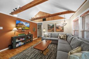 a living room with a couch and a table at Four Bear Falls in Banner Elk