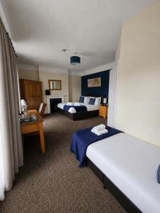 a hotel room with two beds and a room with at The Cornerhouse in Frome +56 photos
