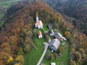 an aerial view of a house with a church at Bungalow Volk Turjaški in Gabrovka