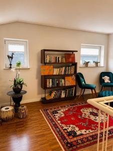 a living room with a book shelf filled with books at Quiet & Friendly Bremen in Bremen