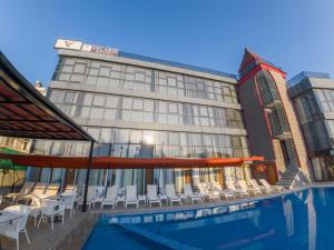a hotel with a swimming pool in front of a building at Velaris Boutıque Hotel in Belek