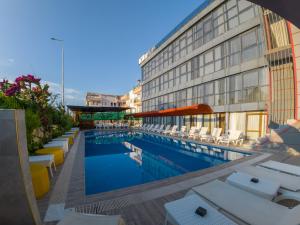 a hotel with a swimming pool next to a building at Velaris Boutıque Hotel in Belek +105 photos