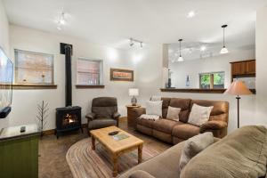 a living room with a couch and a fireplace at Mission Rock 2 in Ouray