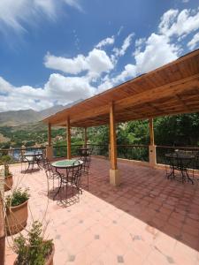 a pavilion with tables and chairs on a patio at Azul Atlas Lodge in Imlil +39 photos
