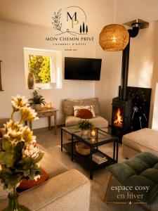a living room with a couch and a fireplace at Mon Chemin Privé in Mirabel-aux-Baronnies