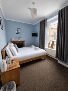 a hotel room with a bed and a window at The Cornerhouse in Frome