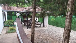 a backyard with a swing set and a gazebo at Palić Libero Apartman in Palić