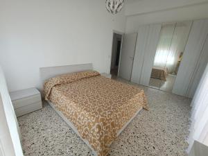 a bedroom with a bed in a white room at Sant' Agostino Suite in Trapani
