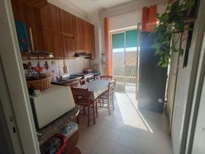 a kitchen with a table and chairs and a window at Sant' Agostino Suite in Trapani