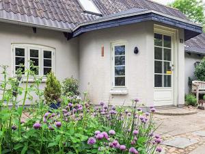 a house with a garden of flowers in front of it at 8 person holiday home in Fur in Fur +28 photos