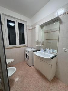 a bathroom with a sink and a washing machine at Mas de le Contesse in Ton +12 photos