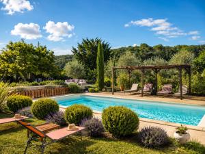a swimming pool in a garden with a gazebo at Mon Chemin Privé in Mirabel-aux-Baronnies