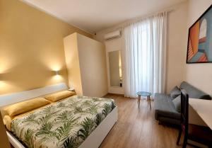a bedroom with a bed and a couch in it at Relais Principe Umberto in Naples