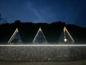 a building with triangular roofs at night at Bujtina Panorama Kir in Kashec